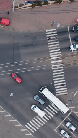 aero shooting from above at the crossroads. city traffic. traffic jams during rush hour in the city. white road markings. vertical video