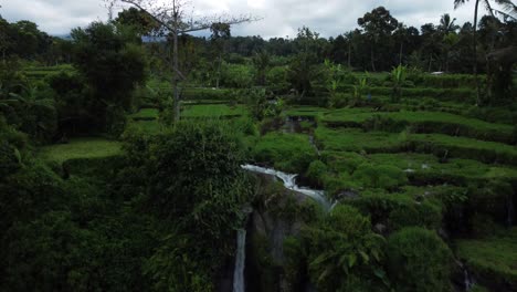 aerial drone soaring over kembar arum waterfall in east java, indonesia