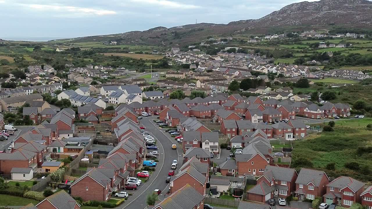 Welsh townhouse modern property aerial view panning across the rocky mountain neighbourhood
