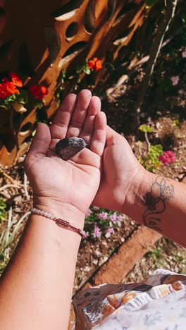 woman holding a stone in a garden