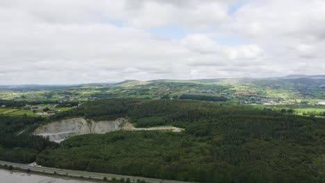 aerial flight over flagstaff viewpoint area, countryside, newry, northern ireland, busy motorway during the summer on a sunny day