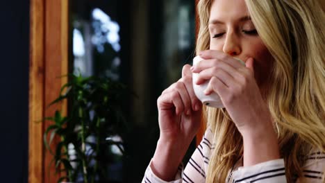 Woman-having-coffee-in-cafÃ©