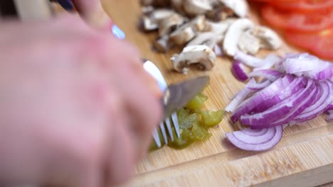 close-up of hands slicing green jalapeño peppers. healthy food from raw ingredients
