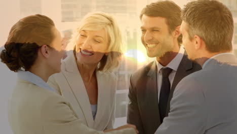 animation of happy caucasian businesspeople shaking hands over landscape at sunset
