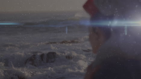wearing red hat, child gazing at ocean with lens flare effect animation