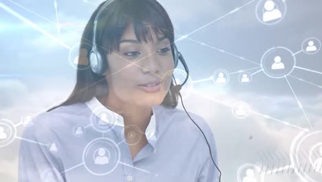 Animation-of-networks-of-connections-with-icons-over-businesswoman-using-phone-headsets