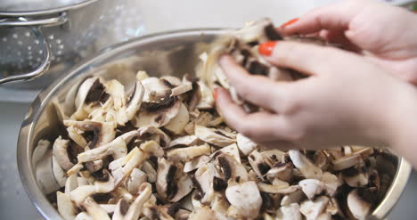 chef slicing mushrooms in kitchen 5