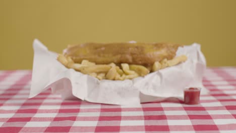Person,-Die-Traditionelles-Britisches-Essen-Zum-Mitnehmen-Mit-Fish-And-Chips-Isst