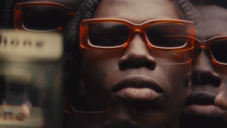 kaleidoscopic effect of cool black man in orange sunglasses