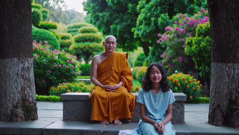 buddhist monk and girl in a temple garden