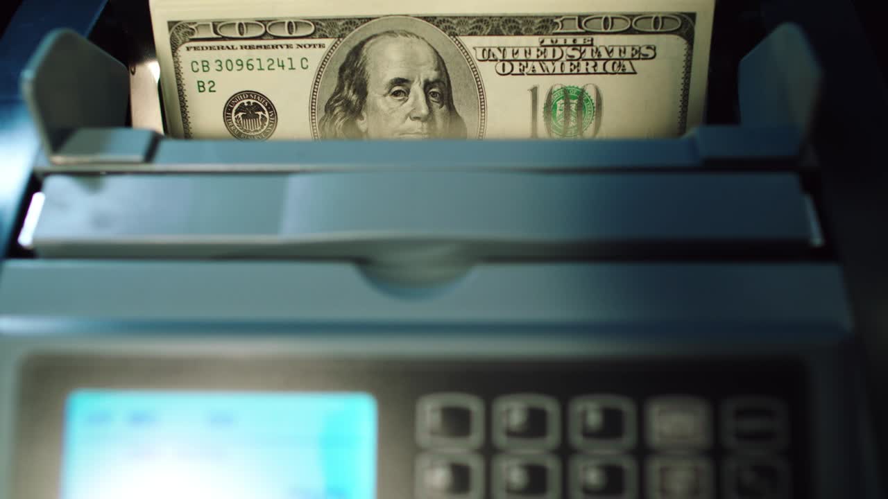 Modern banking services. Cash counting machine counting 100 dollar bills.