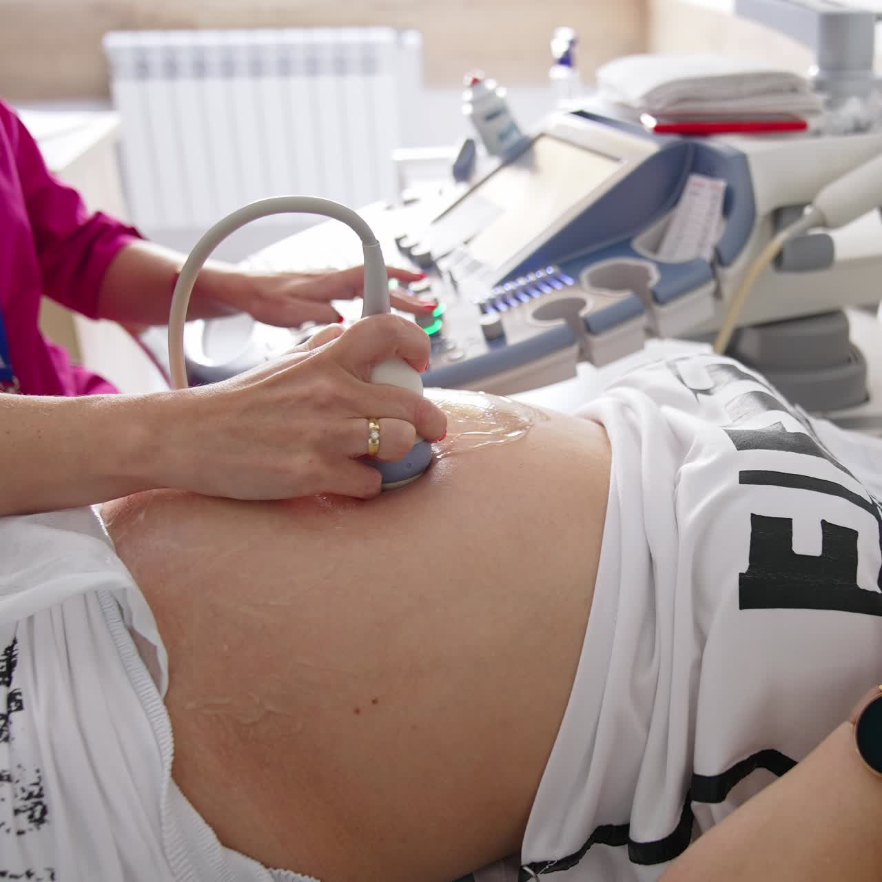 Female doctor doing ultrasound on belly of pregnant woman in clinic. Ultrasound Screening