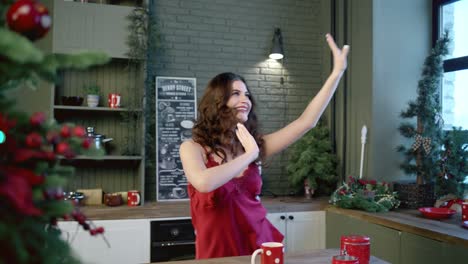woman dancing in a festive christmas kitchen