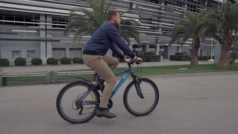 businessman cycling in a modern city park