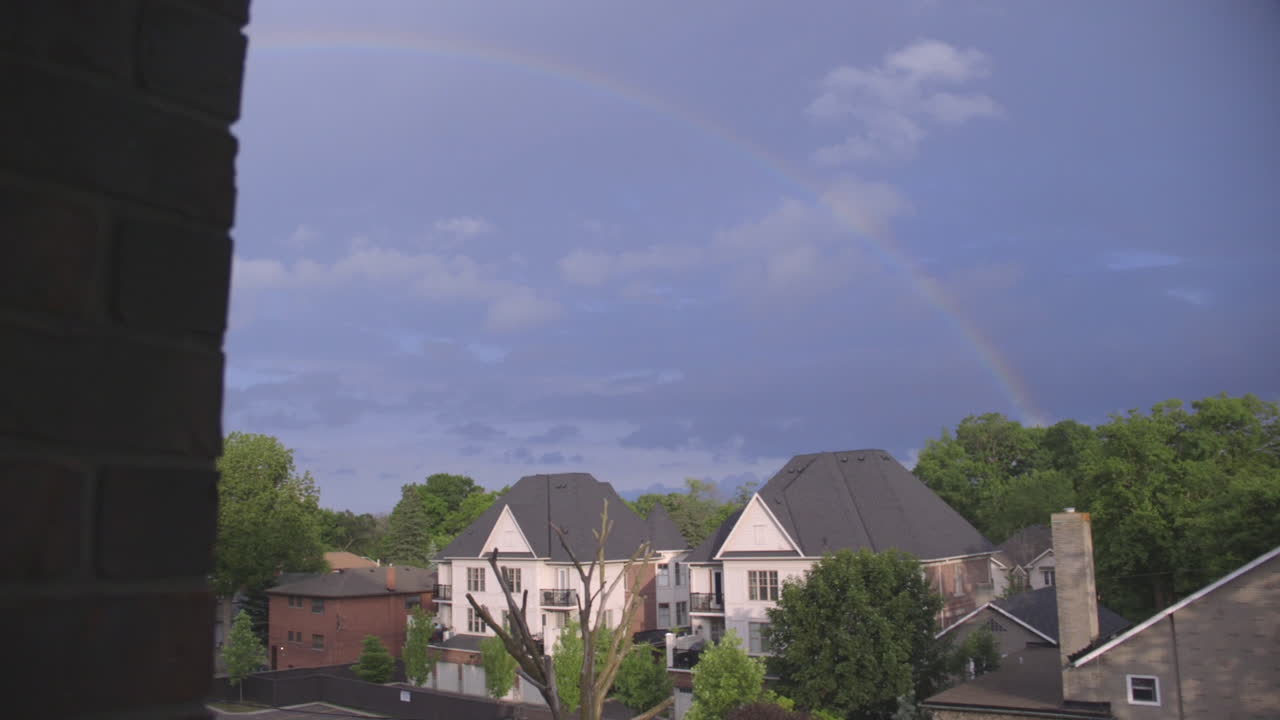 A rainbow appears over a neighbourhood after the storm