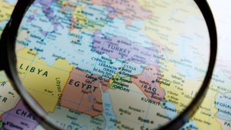 using a magnifying glass, showing a close-up of the countries in the middle east such as israel, egypt, iraq, iran, lebanon, jordan, kuwait, saudi arabia, and many more