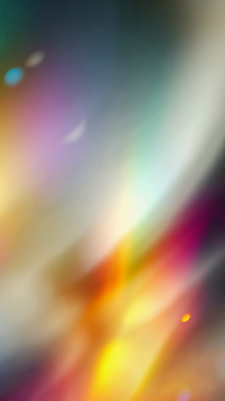 Vertical video: Starting abstract light pattern shifting on screen, with warm gradient hues