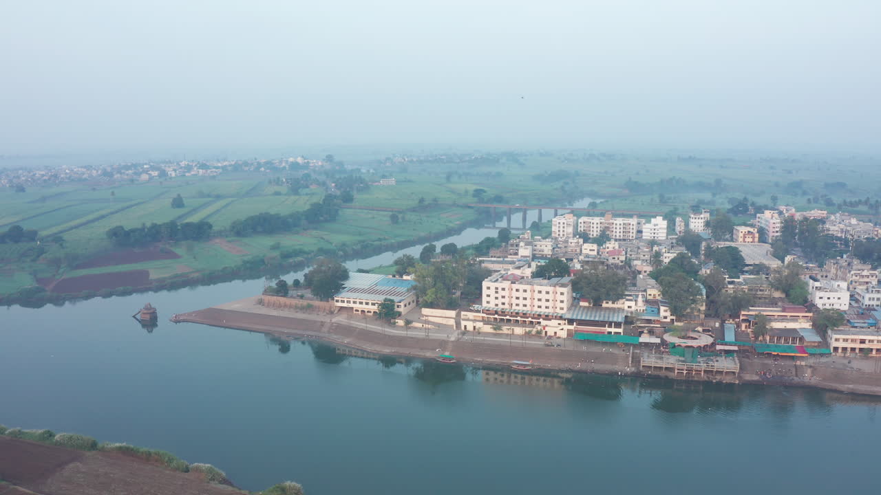 Scenic confluence of Krishna and Panchaganga rivers, with merging waters flowing through picturesque landscapes and rich greenery