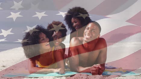 animation of flag of united states of america over happy senior african american family on beach