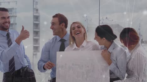 animation of diverse coworkers celebrating at office and connected dots over aerial view of city