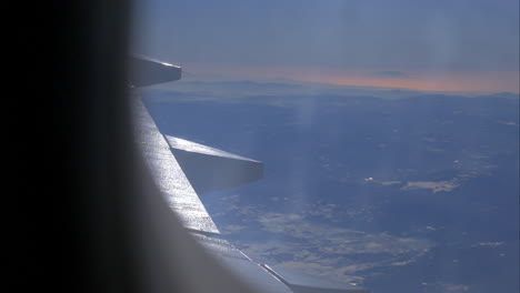 aircraft wing and picturesque mountain landscape from high level from airplane window