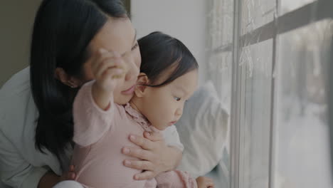 mother and daughter by the window