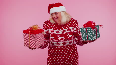 Senior-grandmother-woman-in-Christmas-sweater-holds-two-gift-boxes-in-hands,-shopping-holidays-sale