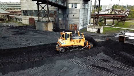 crawler bulldozer sorts coal. industry. aerial view.