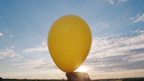 Air-Comes-From-The-Red-Air-Balloon-And-It-Becomes-Limp-Against-The-Background-Of-The-Blue-Sky