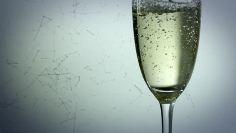 animation of network of connections and bubbles rising in glass of champagne, on grey background