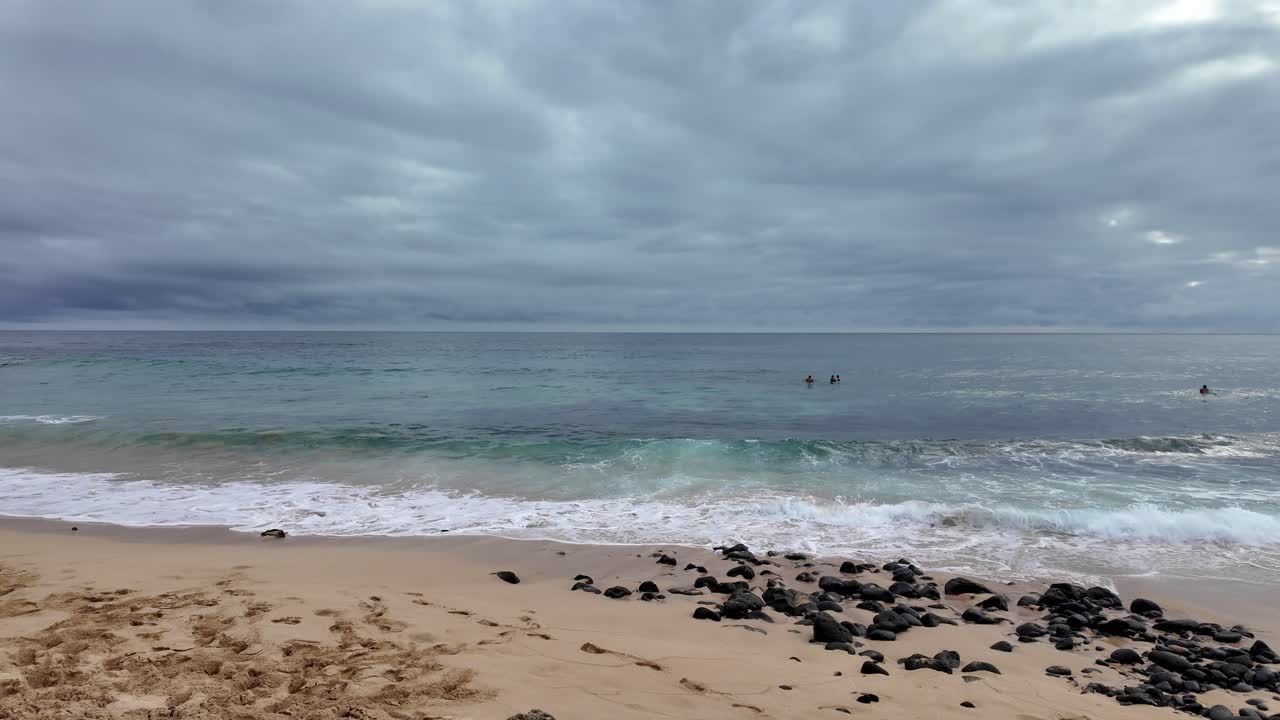 Shipwreck Beach on Kauai, Hawaii known for surfing and sunset viewing popular spot for cliff jumping, at sunset. Beach at Grand Hyatt Kauai Resort Spa