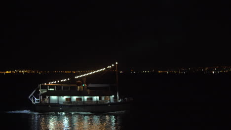 boat with illumination sails at night