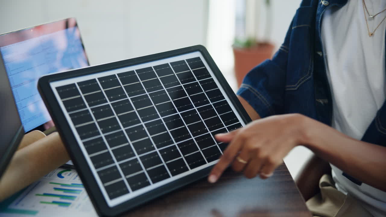 Person's Hand Interacting with a Small Solar Panel
