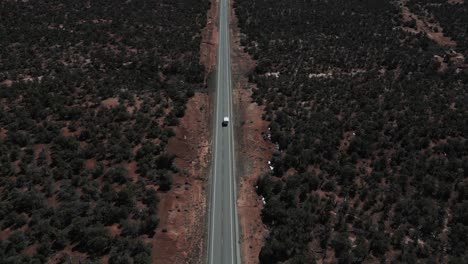 A-lone-camper-truck-navigates-the-road,-crossing-the-desolate-landscapes-of-Utah,-USA,-van-life,-a-lifestyle-defined-by-freedom,-exploration,-and-the-endless-journey-of-the-open-road