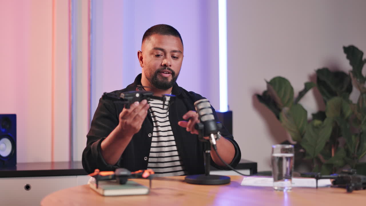 Man recording a podcast about drones in a studio