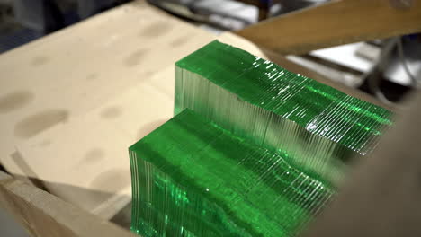 Sheets-of-factory-manufactured-tempered-clear-green-glass-in-a-wooden-box