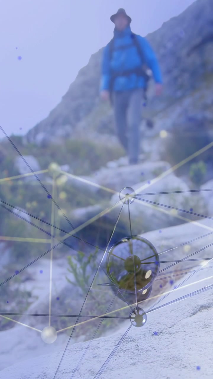 Vertical video: Male hiker nearing cam on rock path, tech overlay nodes spheres scaling for route