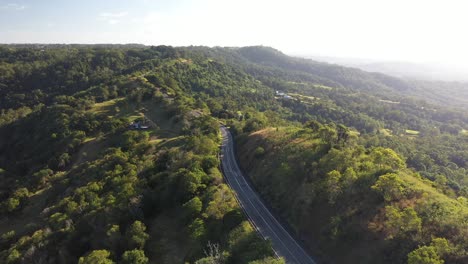 Car-driving-on-a-ridge-of-a-mountain-at-sunrise