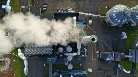 overhead view of steam pouring out of a pulp mill processing plant