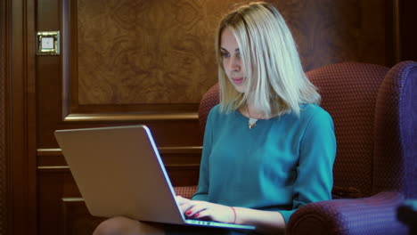 beautiful woman working on notebook screen sitting at table in home office