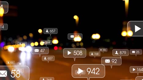 Animation-of-social-media-icons-and-numbers-over-out-of-focus-city-and-traffic-lights