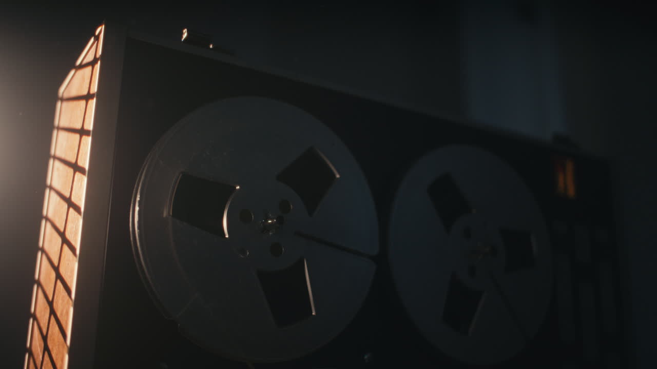 A vintage tape recorder in a red blinking light