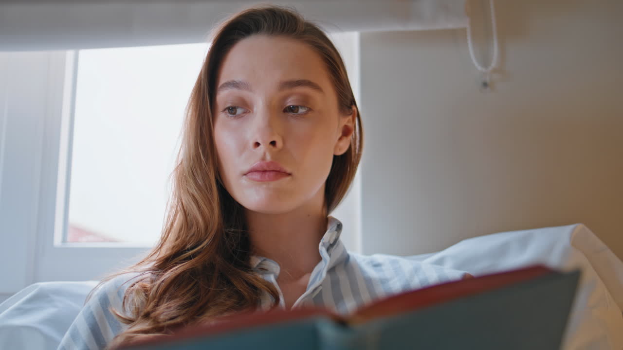 Intellectual woman reading literature in cozy bedroom closeup. Portrait lady