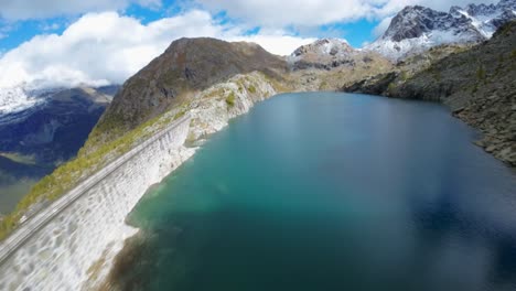 stunning aerial views of an alpine lake and dam