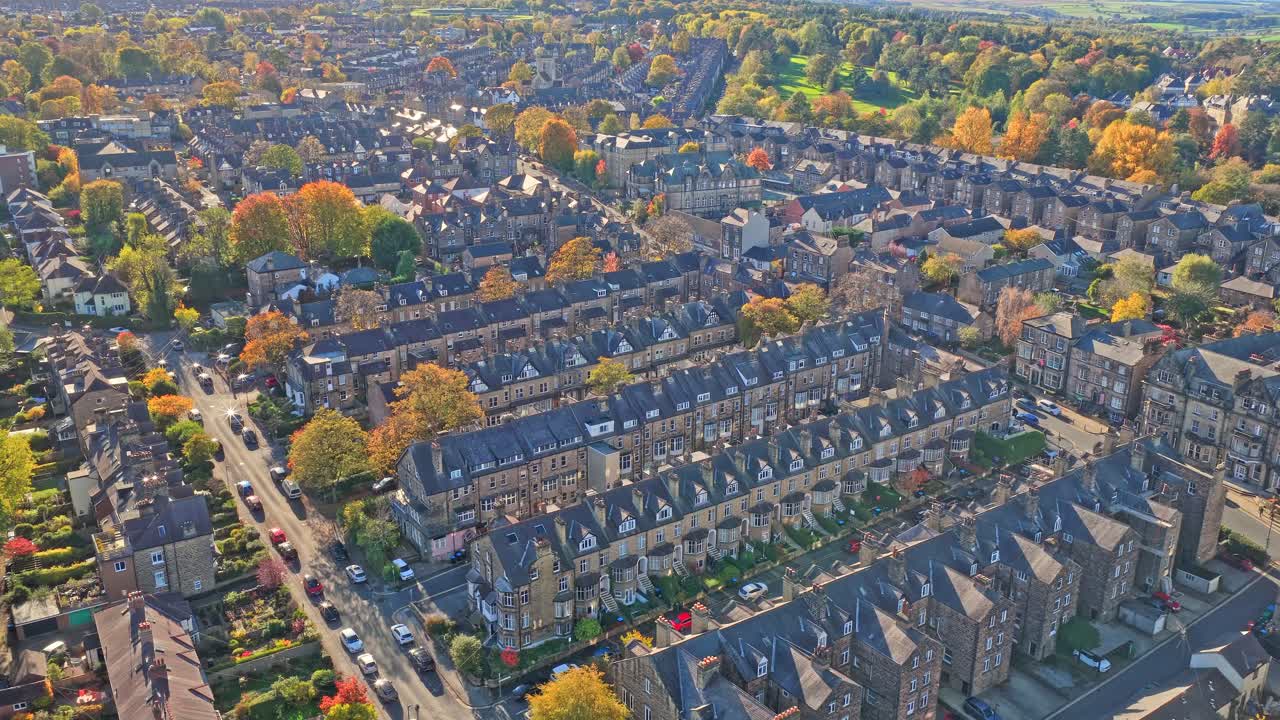 Aerial of Harrogate reveals distinctive Victorian and Edwardian terraced housing built from stone and brick, arranged in geometric rows among leafy streets and vibrant gardens