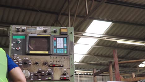 group of factory workers using machine equipment in factory workshop