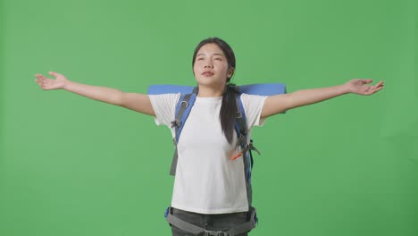 woman traveler with backpack posing on green screen