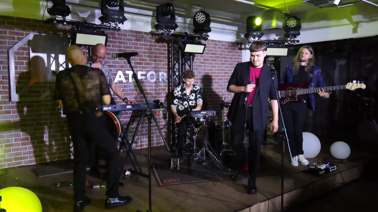 Live concert of a Ukrainian music band Latexfauna in Kyiv Ukraine, singers singing, dancing and having fun on a stage, entertainers performing, 4K shot