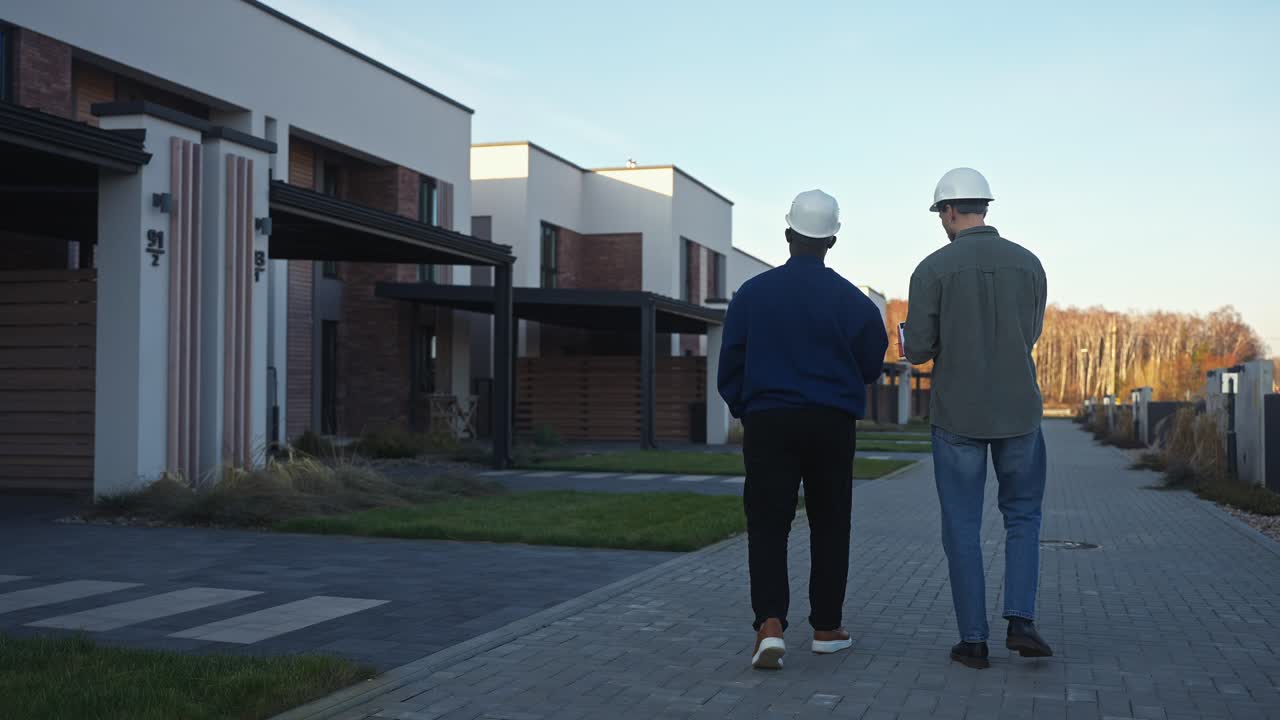Construction Workers Inspecting Modern Homes