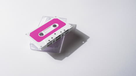 Video-of-retro-tape-with-pink-label-and-clear-box-with-copy-space-on-white-background